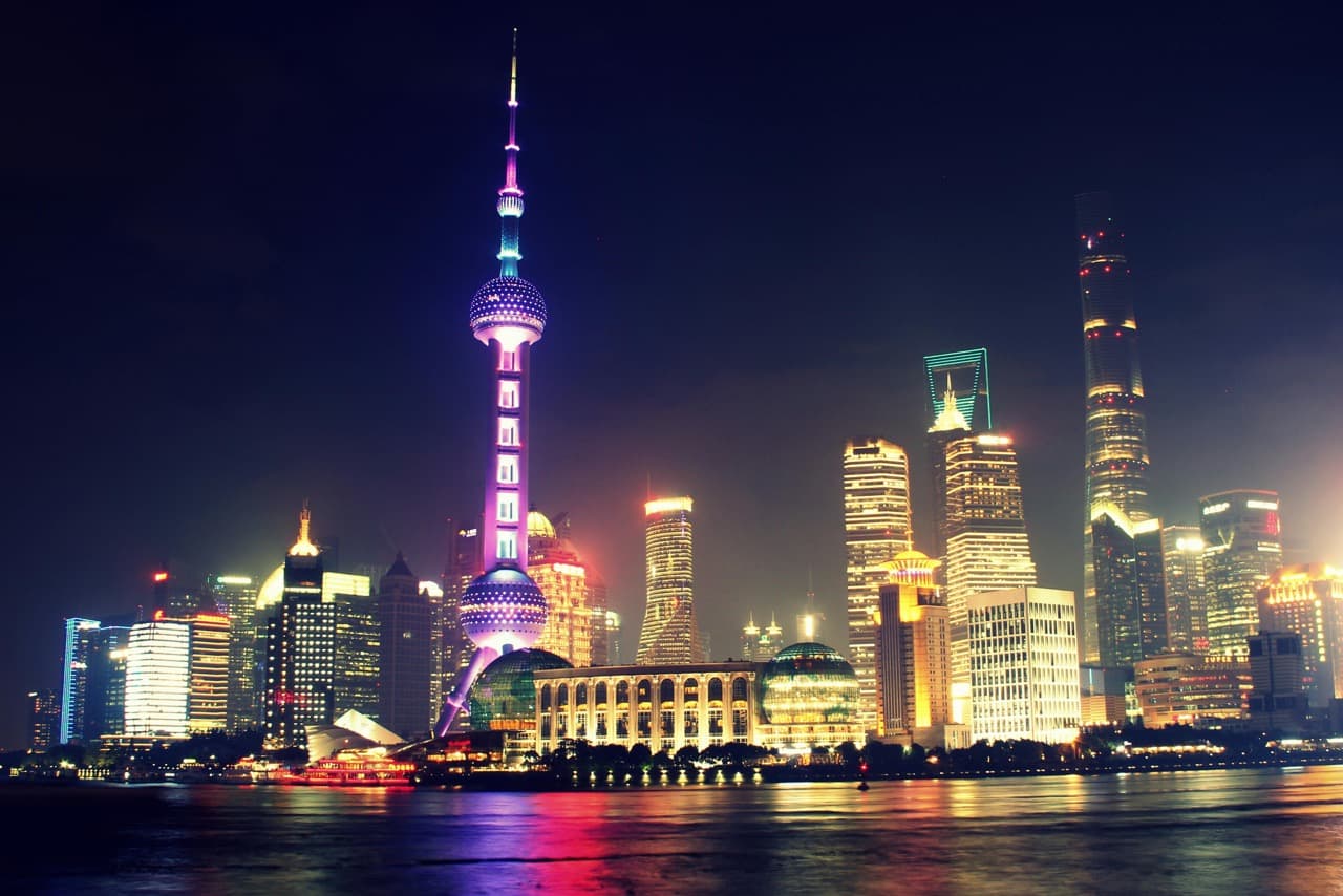 Illuminated Shanghai skyline with Pearl Tower at night.